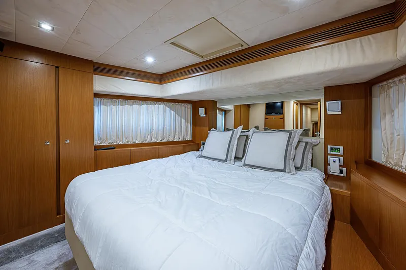 Twe11ve Yacht Photos Pics Luxurious bedroom interior of 2009 Ferretti Yachts 780 MY with elegant wood finishes.