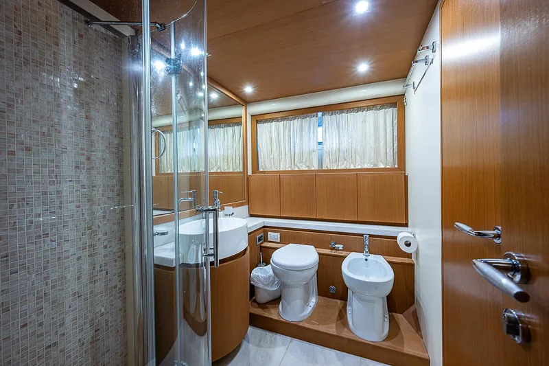 Twe11ve Yacht Photos Pics Luxurious bathroom in 2009 Ferretti Yachts 780 MY with modern fixtures and wood accents.