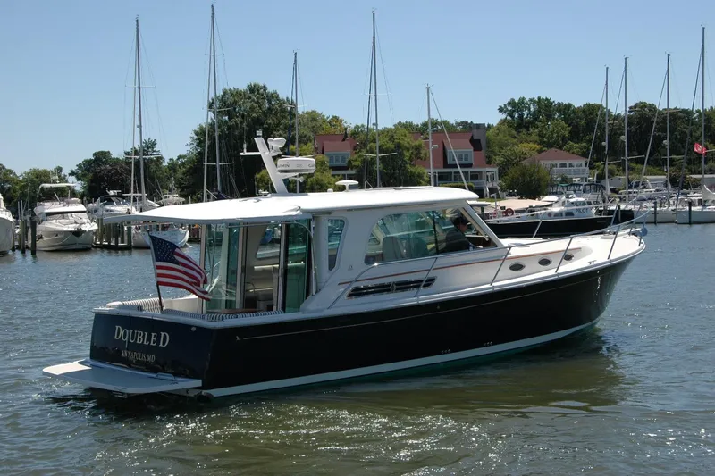 Double D Yacht Photos Pics 2014 Back Cove 37 boat in marina, American flag, sunny day, surrounded by other boats.