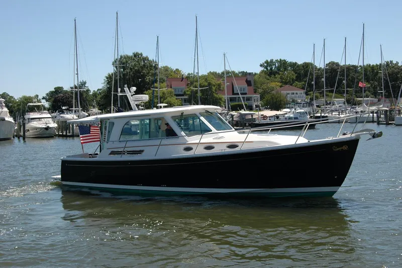 Double D Yacht Photos Pics 2014 Back Cove 37 boat cruising in a marina with sailboats and waterfront homes.