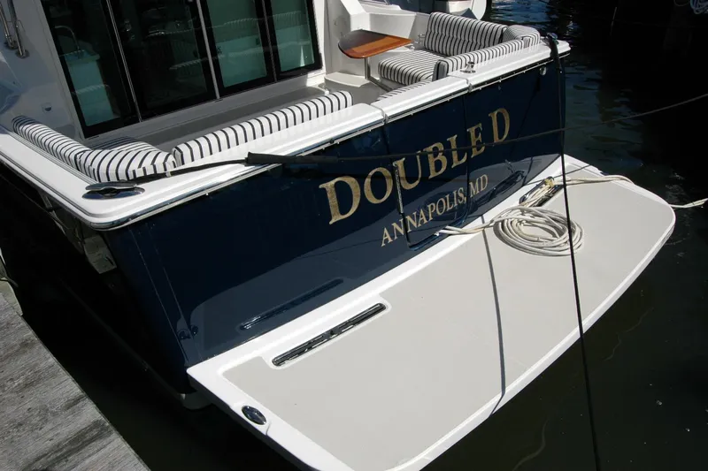 Double D Yacht Photos Pics 2014 Back Cove 37 boat docked, featuring striped seating and "Double D" name.