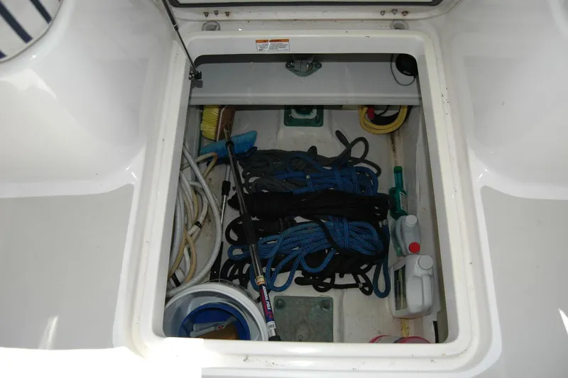 Double D Yacht Photos Pics Storage compartment on a 2014 Back Cove 37 boat with ropes and cleaning supplies.