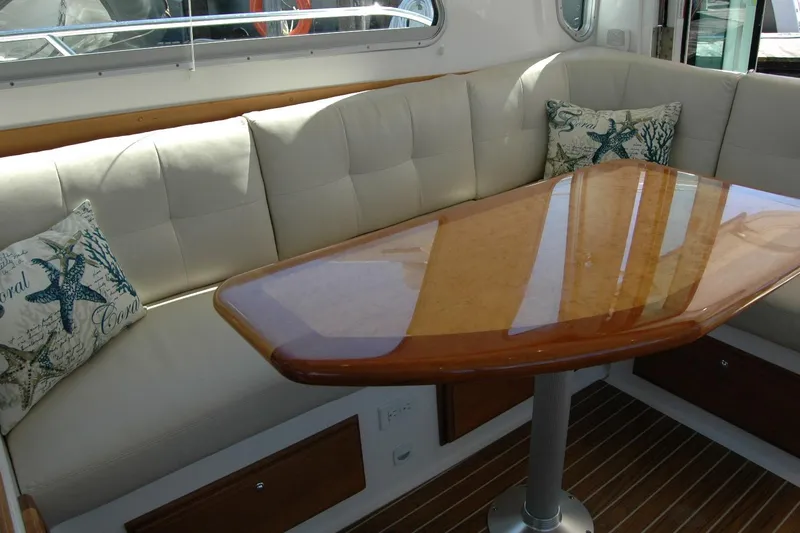 Double D Yacht Photos Pics Luxurious interior of 2014 Back Cove 37 yacht with cushioned seating and elegant wooden table.