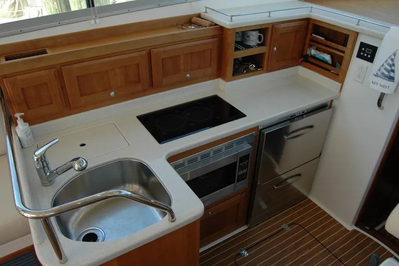 Double D Yacht Photos Pics 2014 Back Cove 37 yacht kitchen with sink, stove, and wooden cabinetry.