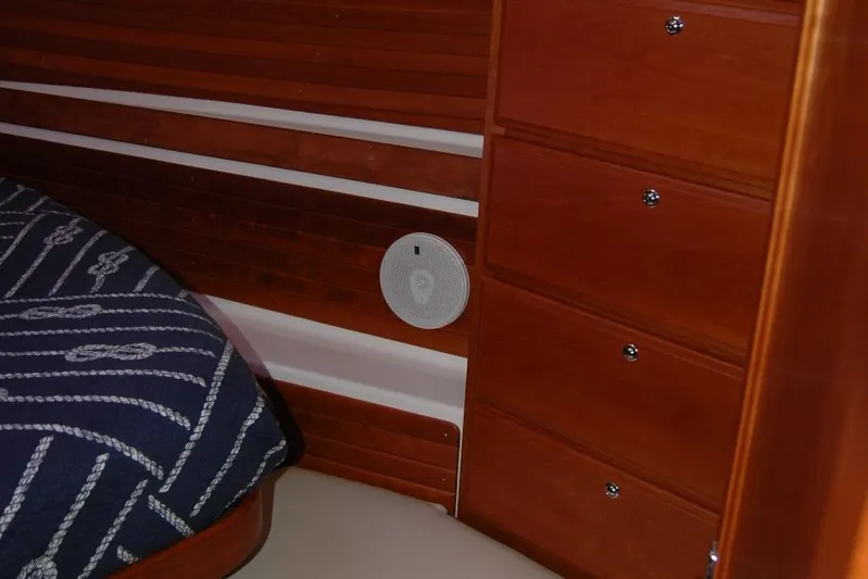 Double D Yacht Photos Pics Interior of 2014 Back Cove 37 boat with wooden drawers and nautical-themed bedding.
