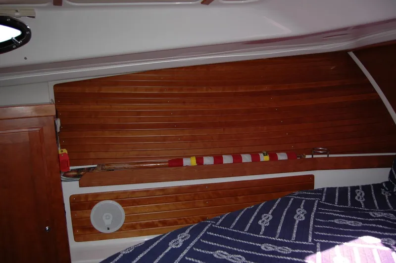 Double D Yacht Photos Pics Interior of 2014 Back Cove 37 boat with wooden paneling and nautical-themed bedding.