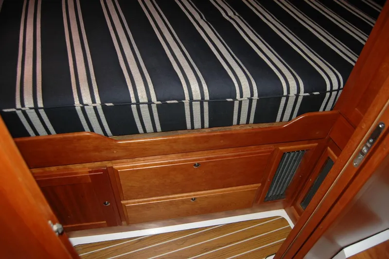Double D Yacht Photos Pics 2014 Back Cove 37 interior with striped bedding and wooden cabinetry.