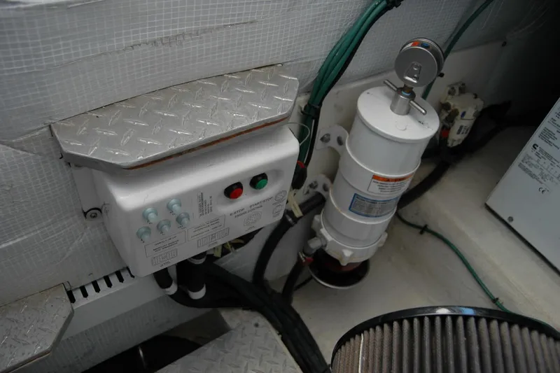 Double D Yacht Photos Pics Engine compartment of a 2014 Back Cove 37 boat, featuring control panel and filter system.