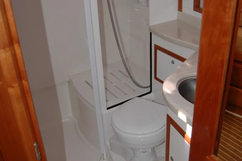 Double D Yacht Photos Pics 2014 Back Cove 37 yacht bathroom with shower, sink, and wooden cabinetry.