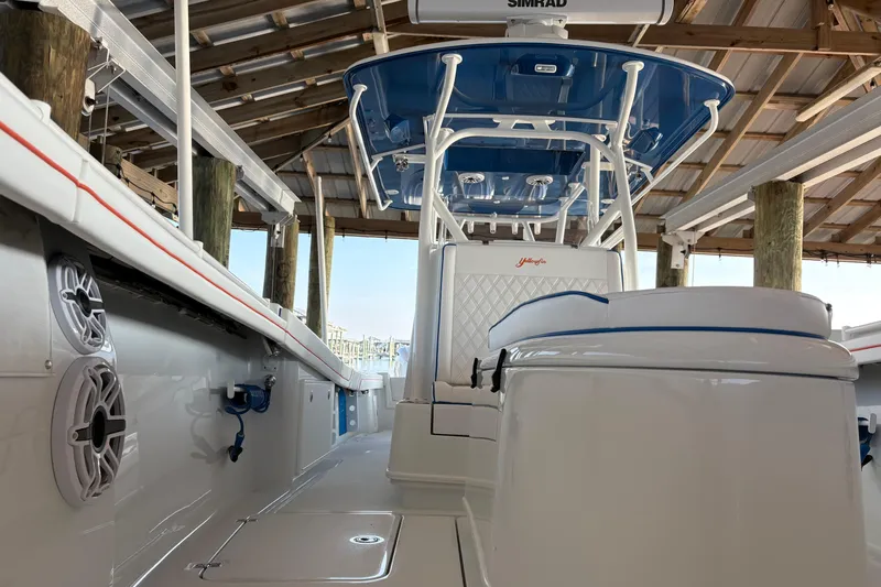 Yacht Photos Pics 2024 Yellowfin 36 Offshore boat interior with blue accents under a wooden dock.