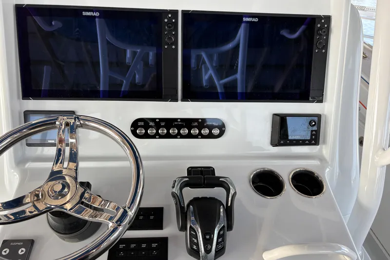  Yacht Photos Pics 2024 Yellowfin 36 Offshore boat dashboard with dual Simrad displays and steering wheel.