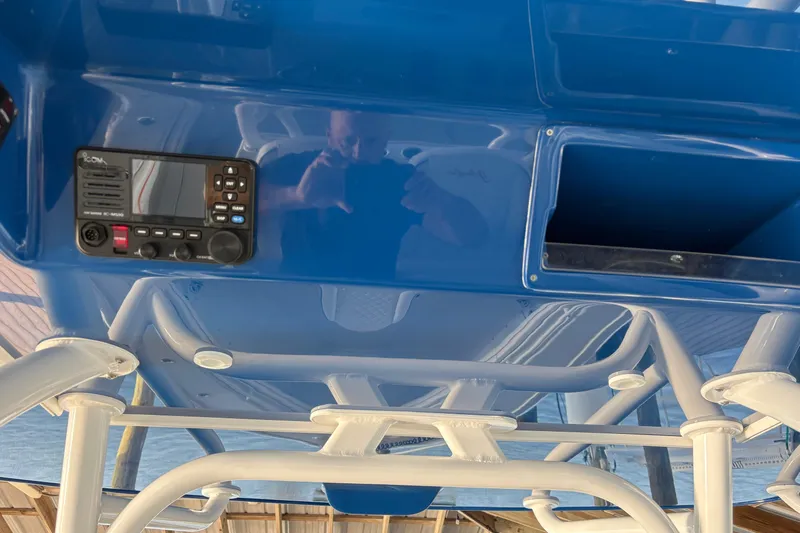  Yacht Photos Pics 2024 Yellowfin 36 Offshore boat console with radio and storage compartment.