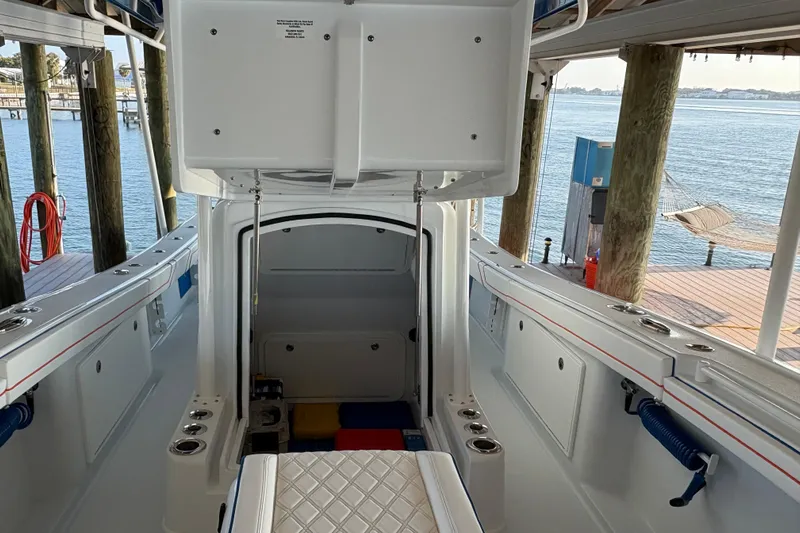  Yacht Photos Pics 2024 Yellowfin 36 Offshore boat interior with open storage compartment, dockside view.