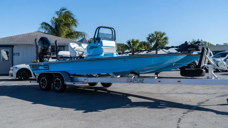  Yacht Photos Pics 2025 SCB S22 boat on trailer, parked outdoors, clear sky background.