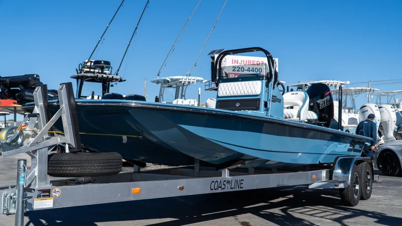  Yacht Photos Pics 2025 SCB S22 boat on trailer, displayed at a marina under clear blue sky.