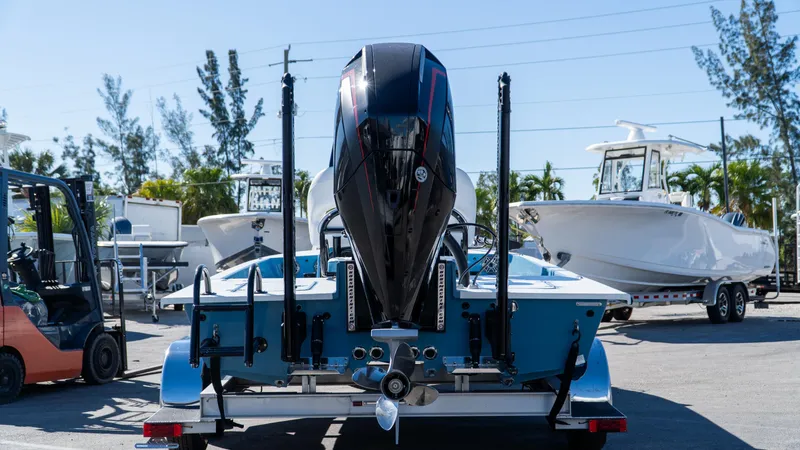  Yacht Photos Pics 2025 SCB S22 boat with powerful outboard motor in a marina setting.