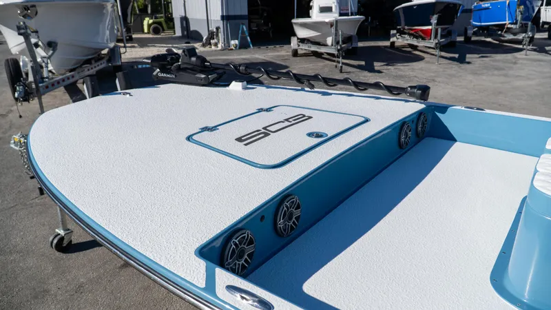  Yacht Photos Pics 2025 SCB S22 boat deck with speakers and storage, parked outdoors.