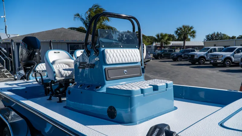  Yacht Photos Pics 2025 SCB S22 boat with blue and white seating, parked outdoors.