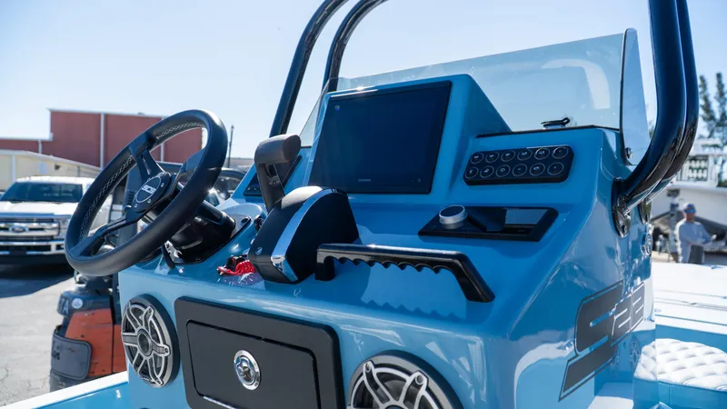  Yacht Photos Pics 2025 SCB S22 boat dashboard with steering wheel and control panel.