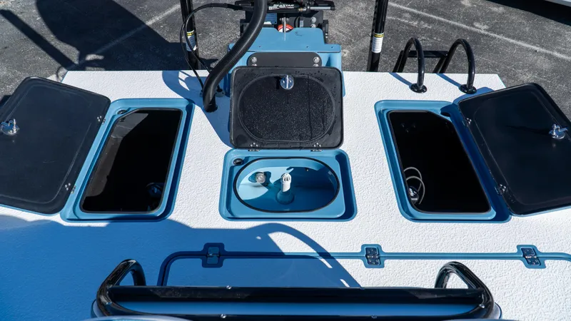  Yacht Photos Pics 2025 SCB S22 boat deck with multiple storage compartments and control panel.