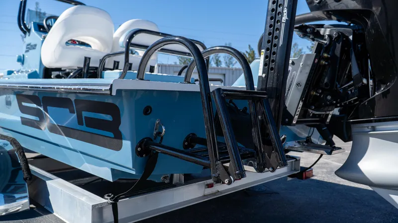 Yacht Photos Pics 2025 SCB S22 boat rear view with ladder and motor, showcasing sleek design.