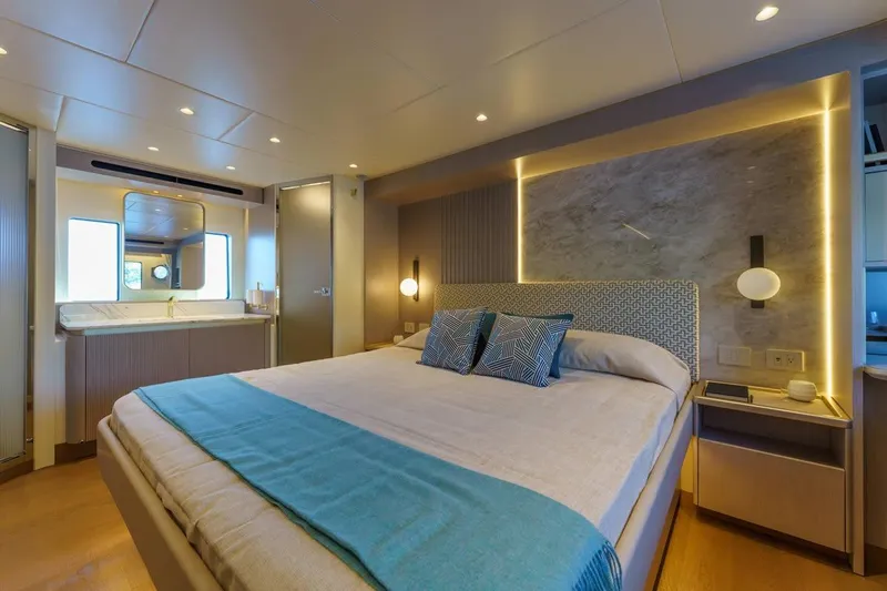  Yacht Photos Pics Luxurious bedroom interior of 2026 Absolute 70 Fly yacht with modern design and ambient lighting.