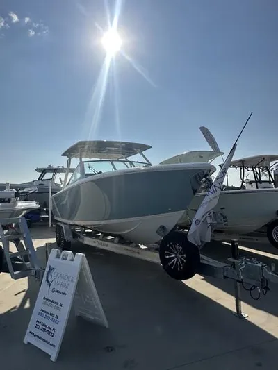  Yacht Photos Pics 2024 Sailfish 276 DC boat displayed under the sun at a marina.