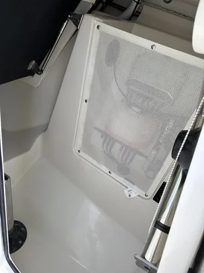  Yacht Photos Pics 2024 Sailfish 276 DC boat storage compartment with mesh cover.