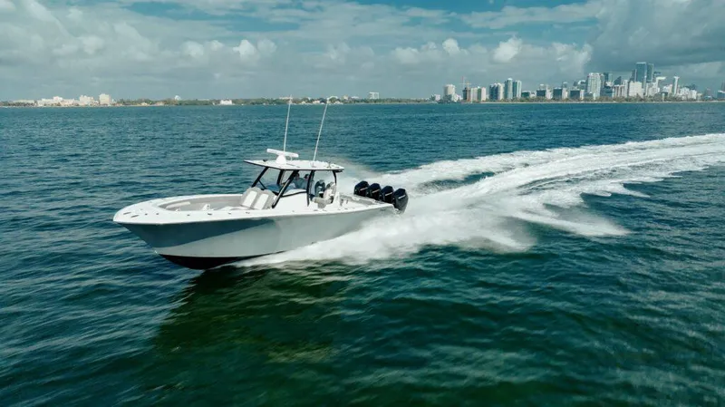  Yacht Photos Pics 2026 Front Runner 39 Center Console boat cruising on open water near a city skyline.