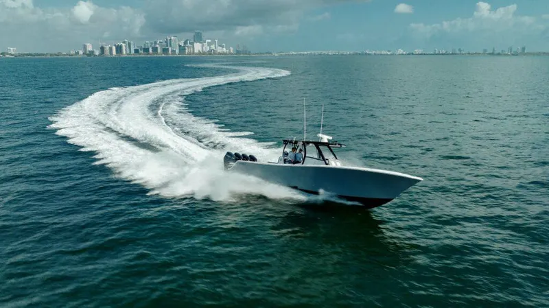  Yacht Photos Pics 2026 Front Runner 39 Center Console boat cruising on open water with city skyline backdrop.