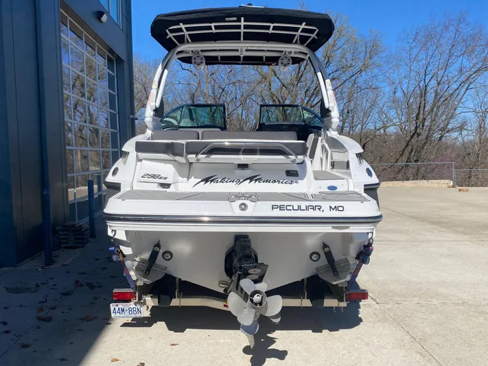  Yacht Photos Pics 2023 Monterey 298 Super Sport BR boat, rear view, parked outdoors near a building.