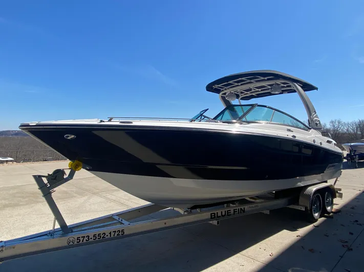  Yacht Photos Pics 2023 Monterey 298 SUPER SPORT BR boat on trailer under clear blue sky.
