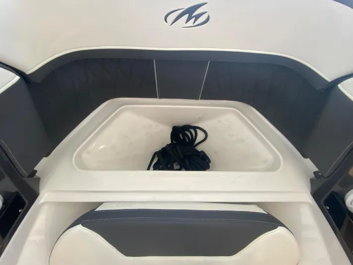  Yacht Photos Pics 2023 Monterey 298 SUPER SPORT BR boat interior with storage compartment and coiled rope.