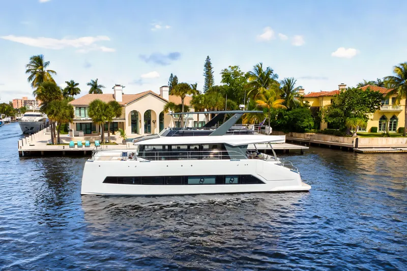 Oceanwalker - Electric - S60e Yacht Photos Pics Electric Oceanwalker S60e yacht cruising near luxury waterfront homes, 2026 model.