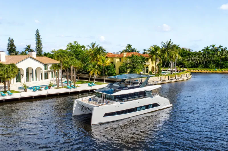 Oceanwalker - Electric - S60e Yacht Photos Pics Luxurious Oceanwalker S60e electric yacht cruising near waterfront villas, 2026 model.