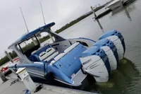 2018 Mystic Powerboats M4200 with triple Mercury engines docked in a marina.
