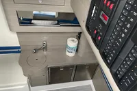 2018 Mystic Powerboats M4200 interior with control panel, sink, and storage cabinets.