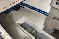 2018 Mystic Powerboats M4200 cabin interior with seating and compact sink area.