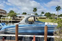 2018 Mystic Powerboats M4200 docked, featuring sleek blue design and modern architecture.