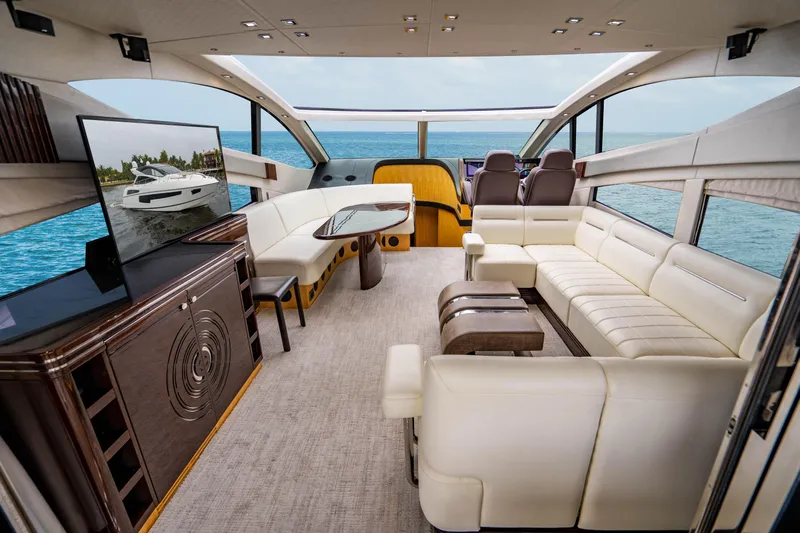 Yolo Yacht Photos Pics Luxurious interior of 2014 Sunseeker Predator yacht with white leather seating and ocean view.