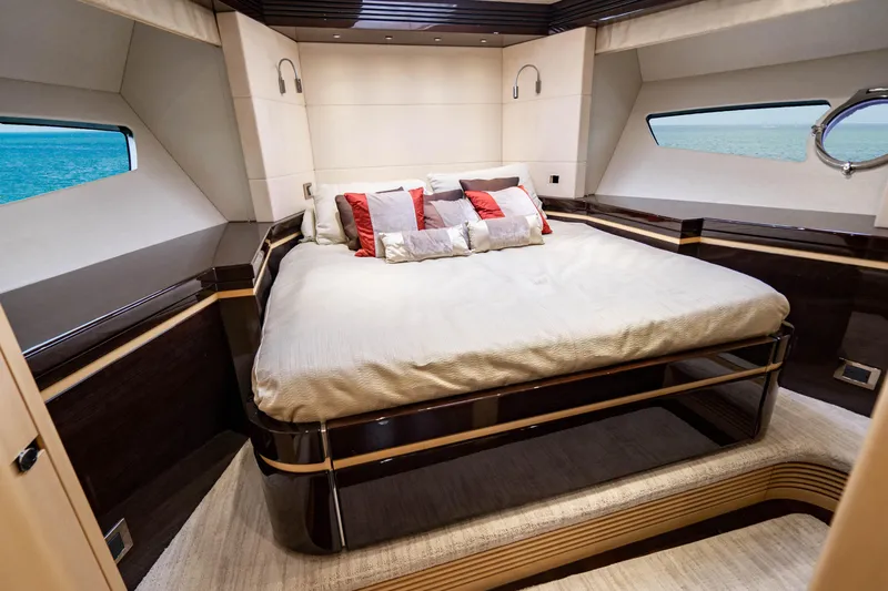 Yolo Yacht Photos Pics Luxurious bedroom in a 2014 Sunseeker Predator yacht with ocean view windows.