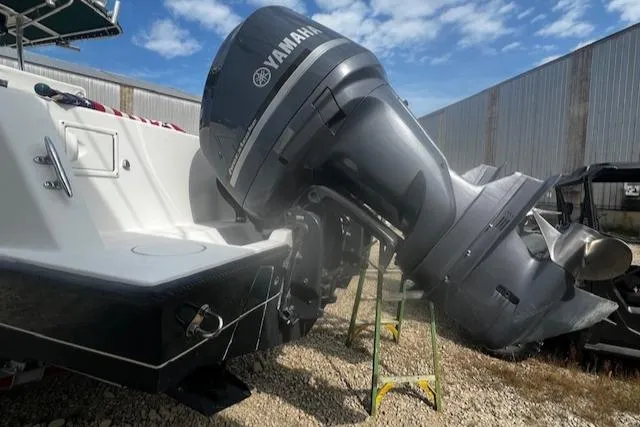  Yacht Photos Pics 1999 Contender 27 Open Center Console with Yamaha outboard motor, parked outdoors.