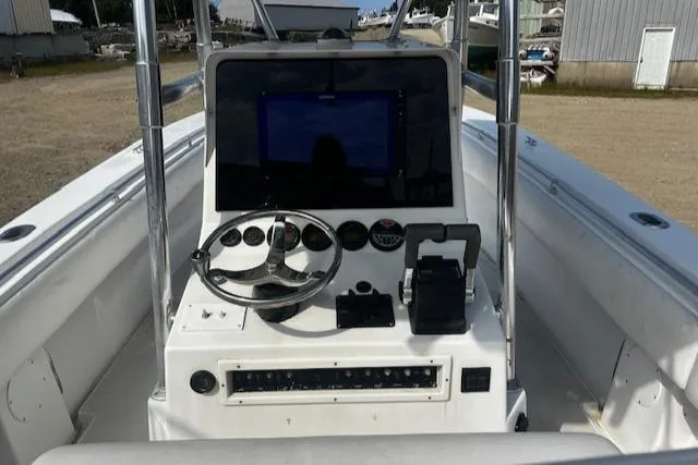  Yacht Photos Pics 1999 Contender 27 Open Center Console boat dashboard with steering wheel and controls.