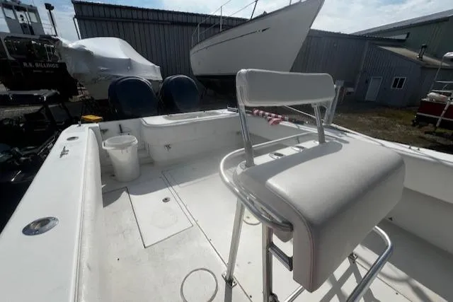  Yacht Photos Pics 1999 Contender 27 Open Center Console boat with seating, docked near other vessels.