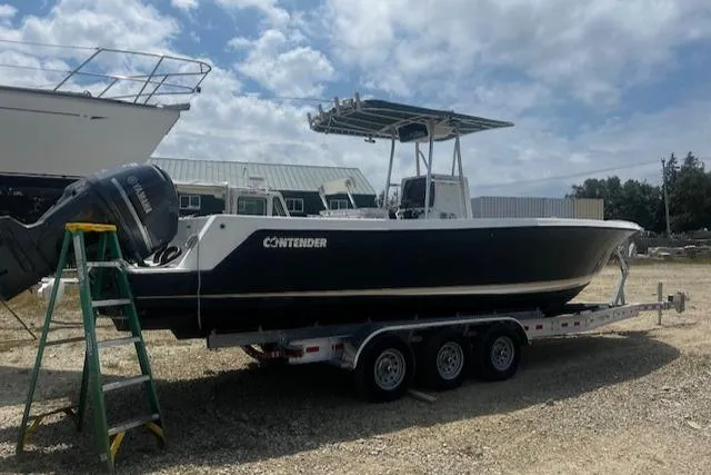  Yacht Photos Pics 1999 Contender 27 Open Center Console boat on trailer, parked outdoors.