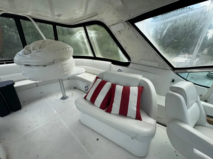 Beautiful Crazy Yacht Photos Pics Interior of 2003 Carver 570 Voyager Pilothouse with white seating and striped cushions.