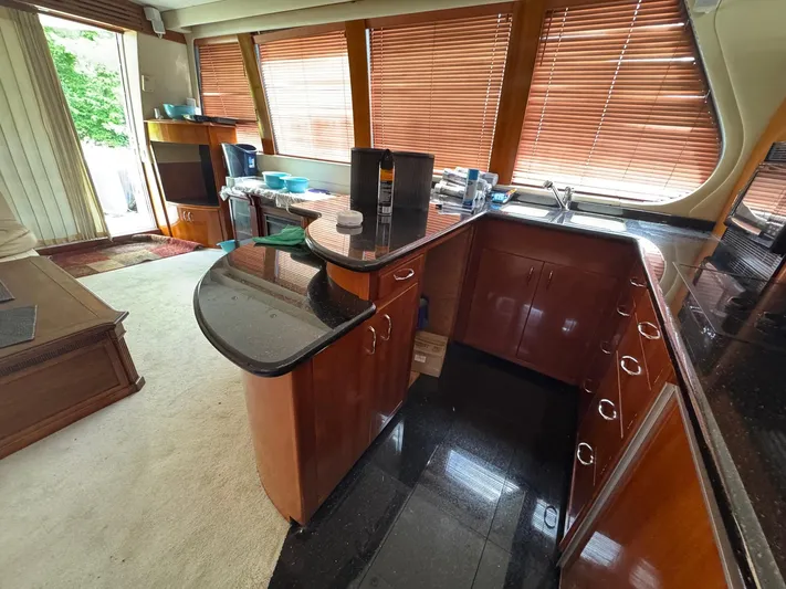 Beautiful Crazy Yacht Photos Pics Luxurious kitchen interior of 2003 Carver 570 Voyager Pilothouse with wood cabinetry and granite countertops.
