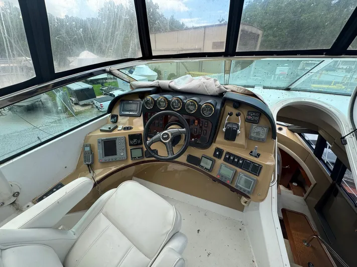 Beautiful Crazy Yacht Photos Pics Pilothouse interior of 2003 Carver 570 Voyager, featuring navigation controls and gauges.