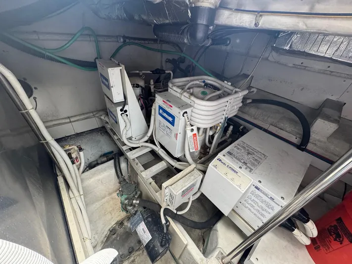Beautiful Crazy Yacht Photos Pics Engine room of 2003 Carver 570 Voyager Pilothouse with mechanical equipment and wiring.
