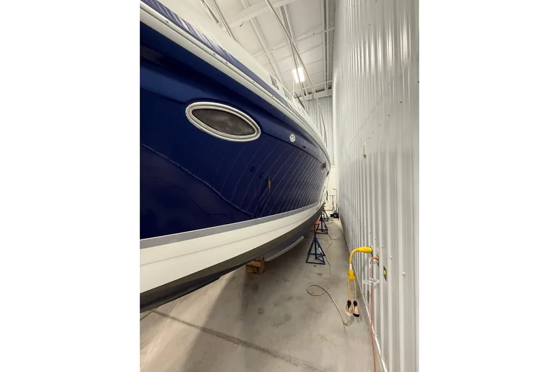  Yacht Photos Pics 2004 Formula 34 Performance Cruiser in storage, blue hull, indoor facility.